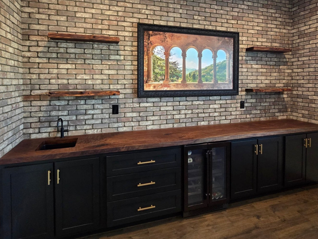 Custom cabinets by Old Soul Cabinetry. This custom cabinetry project features a live edge countertop made from Black (Claro) Walnut and has matching live edge shelving on the back wall. These built-in cabinets were perfectly fitted to the niche and contain luxury hardware and drawer slides.